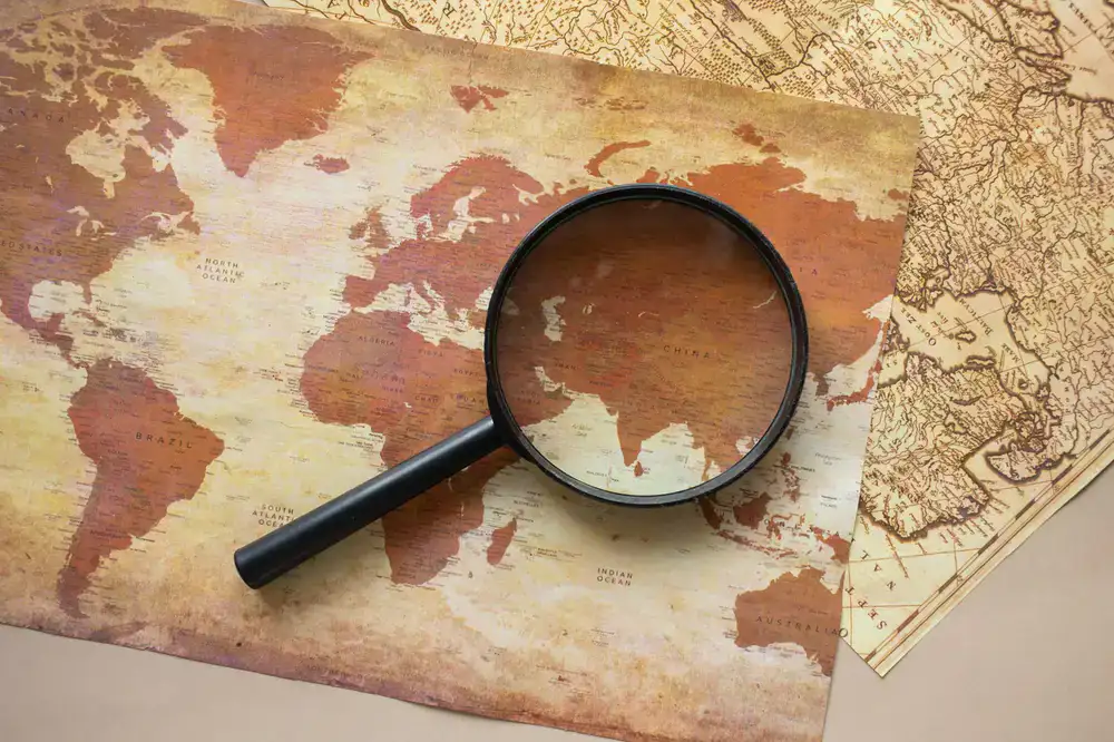 Magnifying glass resting on an old map